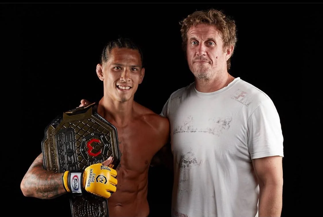 Rich alongside Sam with a championship belt